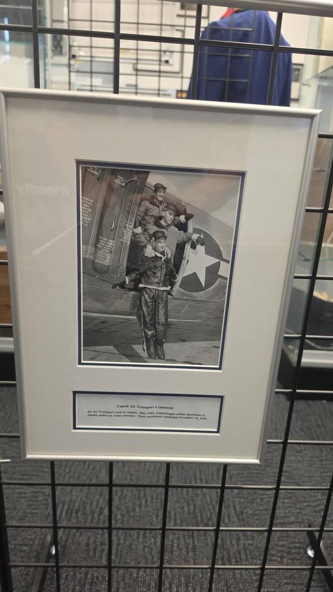 Framed photograph of airmen beside an aircraft