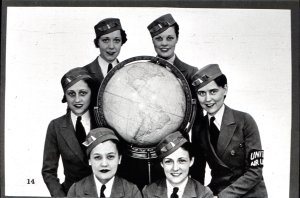 The uniform cap became more streamlined and United became more publicity conscious as witness the arm band on the young woman at right.