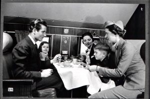 ...this stewardess shown assisting a flying family aboard a sleeper version of the DC-3. The sleeper plane brought many additional comforts 