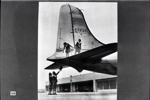 ...and here, four of United's stewardesses are shown looking over a Douglas C-54, military version of the four-engine planes which will take