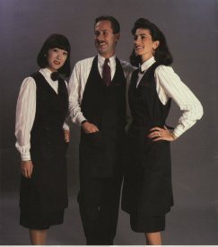 The full length serving garment was navy double breasted with burgundy accents and tied with a wrap belt in back. On International flights i