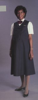 The navy double breasted maternity jumper was designed to complement the double-breasted suit. It featured mock lapels, navy embossed United
