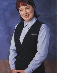 The matching suit vest with a notched collar buttoned at the waist featured two navy buttons embossed with the United logo and faux flap poc