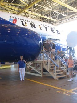 (Left) UAHF director Carole Tye strikes a pose under the engine of United’s B747 as she waits her turn to tour the aircraft. (Right) United 