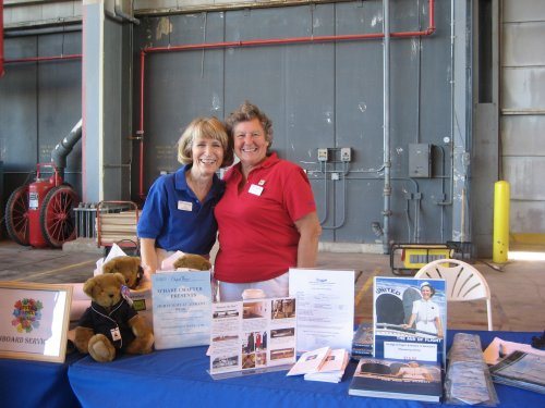 Jan Brown and Christel Ilg are shown at the table Clipped Wings® shared with the United Airlines Historical Foundation.