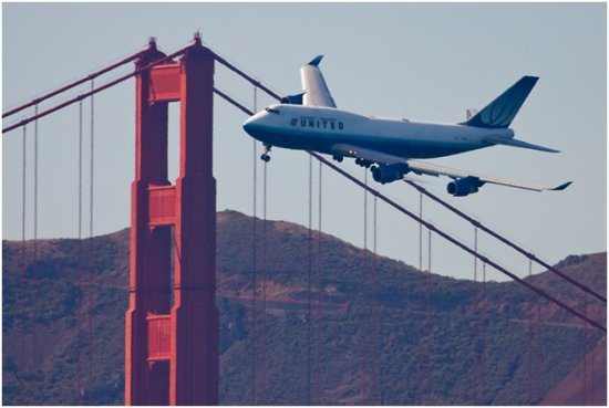 United’s widebody Boeing 747 makes an impressive sight as it passes in front of San Francisco’s world famous Golden Gate Bridge.