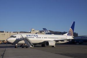 Left – Airplane tails of the newly merged companies (L – Continental and R – United) are positioned next to each other. Right - United’s new