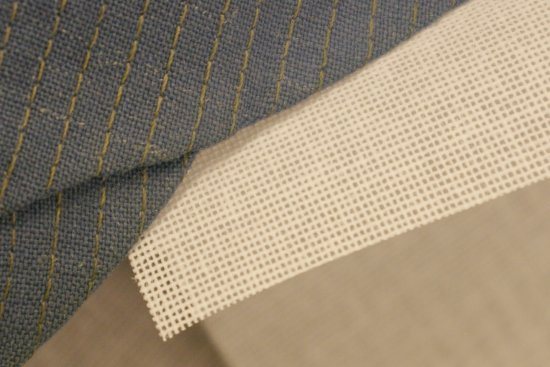 Laura Coats displays buckram, the stiffening fabric used to restore crispness to vintage uniform hats