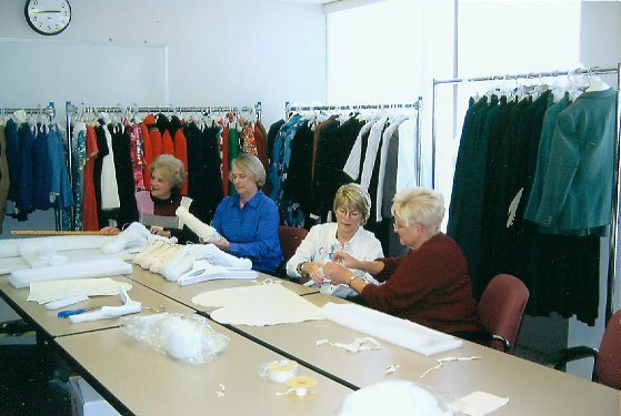 Back to Front: Barbara Sakely, Linda Davis, Carole Tye and Marlene Dudek. In production line style, volunteers trace and cut pattern parts f