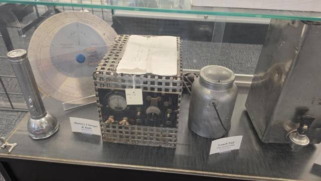 Early radio gear, a flashlight and a lunch pail