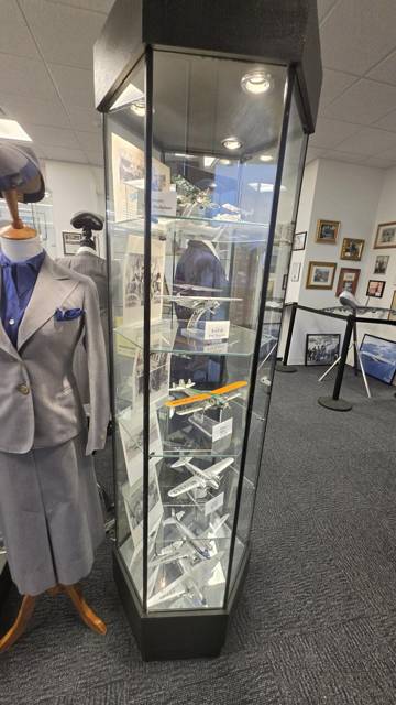 Stewardess uniform beside a case of models