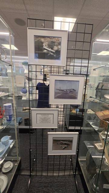 Framed aircraft photographs on a display grid