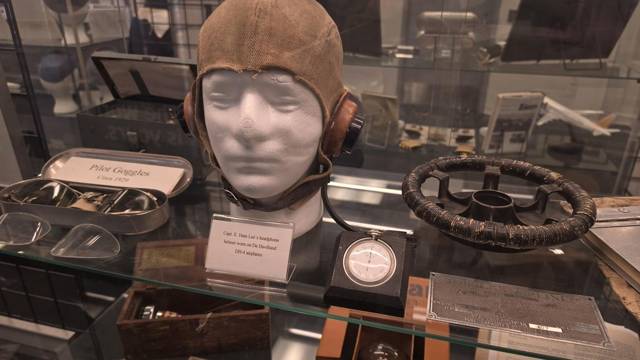 Leather flying helmet, goggles and a pocket watch
